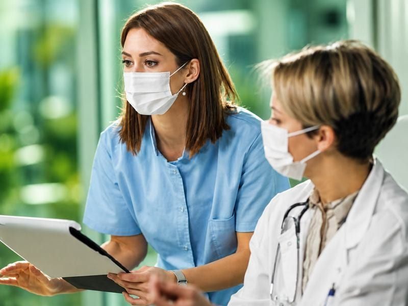Clinicians reviewing a patient journey on a tablet